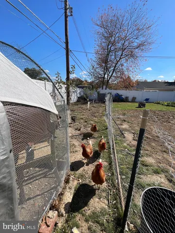 a view of a patio with a table and chairs under an umbrella