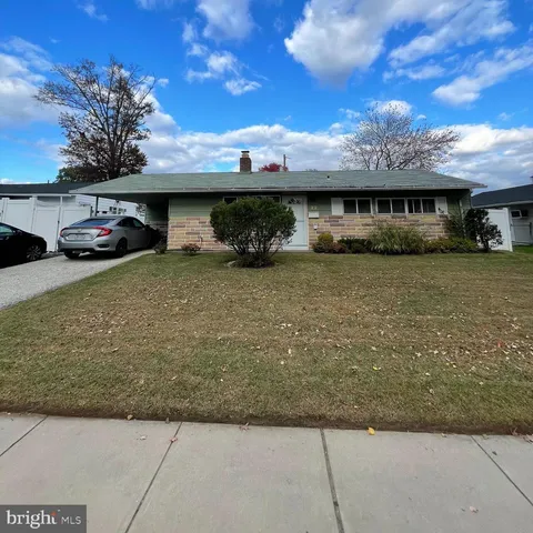a view of a house with a patio and a yard
