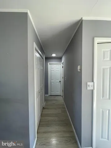 a view of hallway with wooden floor