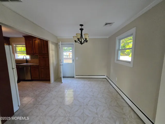 an empty room with windows and entrance