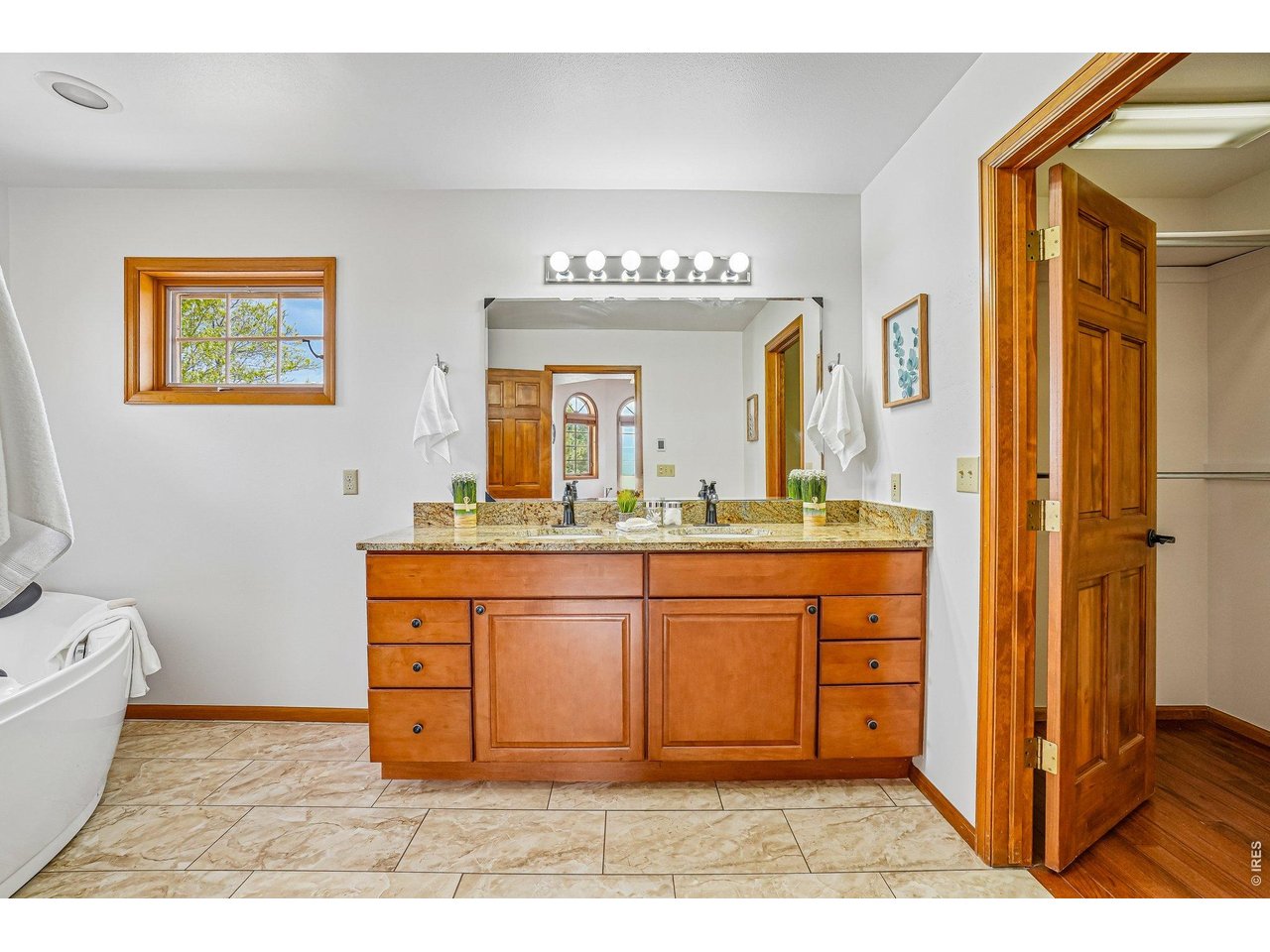 9743 Yellowstone Road Longmont, CO 80504 - Photo 26 of 50 En suite bathroom with a soaking tub and walk in closet