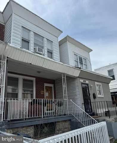 a view of a house with wooden deck and furniture