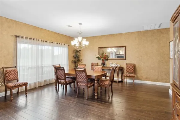 a view of a dining room with furniture window and wooden floor
