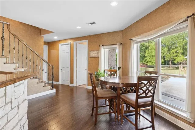 a dining room with wooden floor outdoor seating and windows