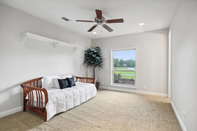 a bedroom with a large bed and a window