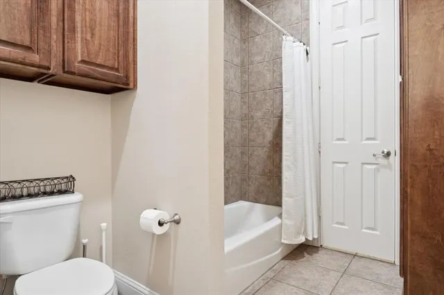 a bathroom with a toilet and bathtub