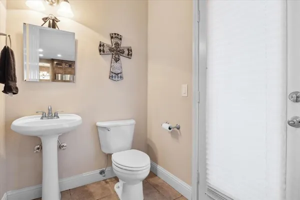 a bathroom with a sink a toilet and mirror