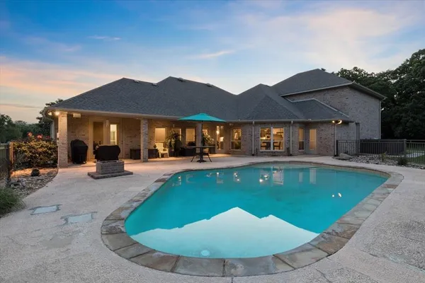 a view of a house with swimming pool and sitting area