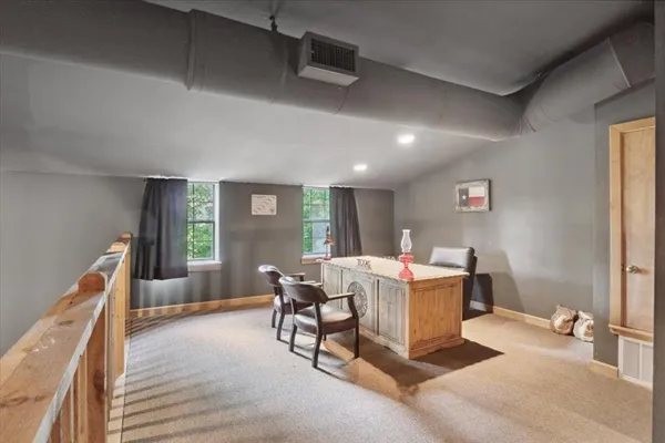 a living room with furniture a flat screen tv and a table