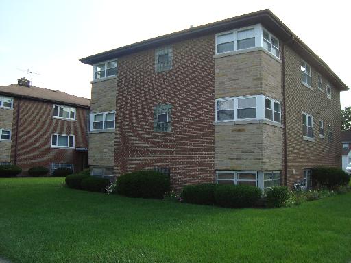 3000 South Harlem Avenue, Unit 2E Riverside, IL 60546 - Photo 1 of 1 a brick house with a small yard