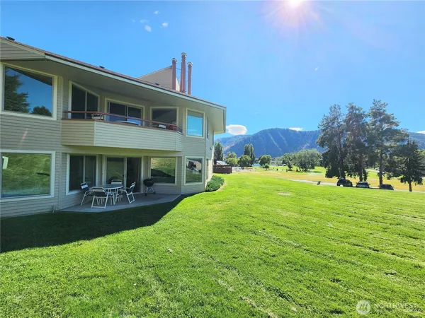 a front view of house with yard and outdoor seating