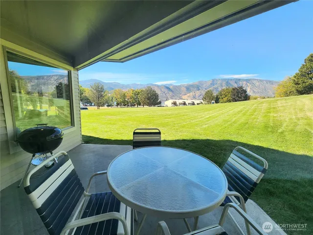 a view of a swimming pool and an ocean from a balcony