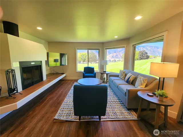 a living room with furniture fireplace and a flat screen tv