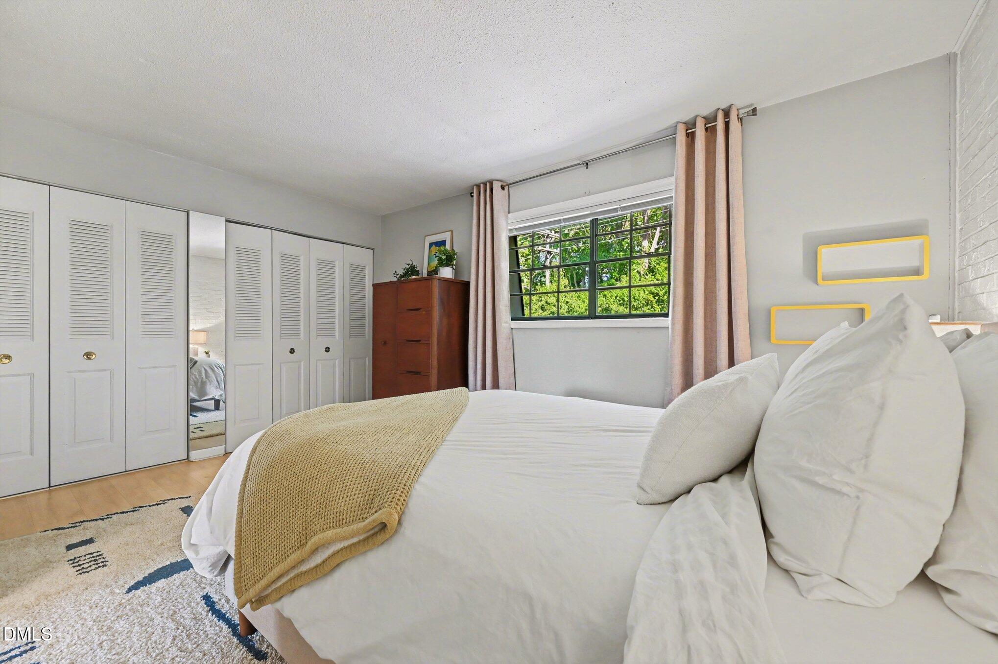 807 West Trinity Avenue, Unit 252 Durham, NC 27701 - Photo 11 of 23 a bed room with a bed and a chair