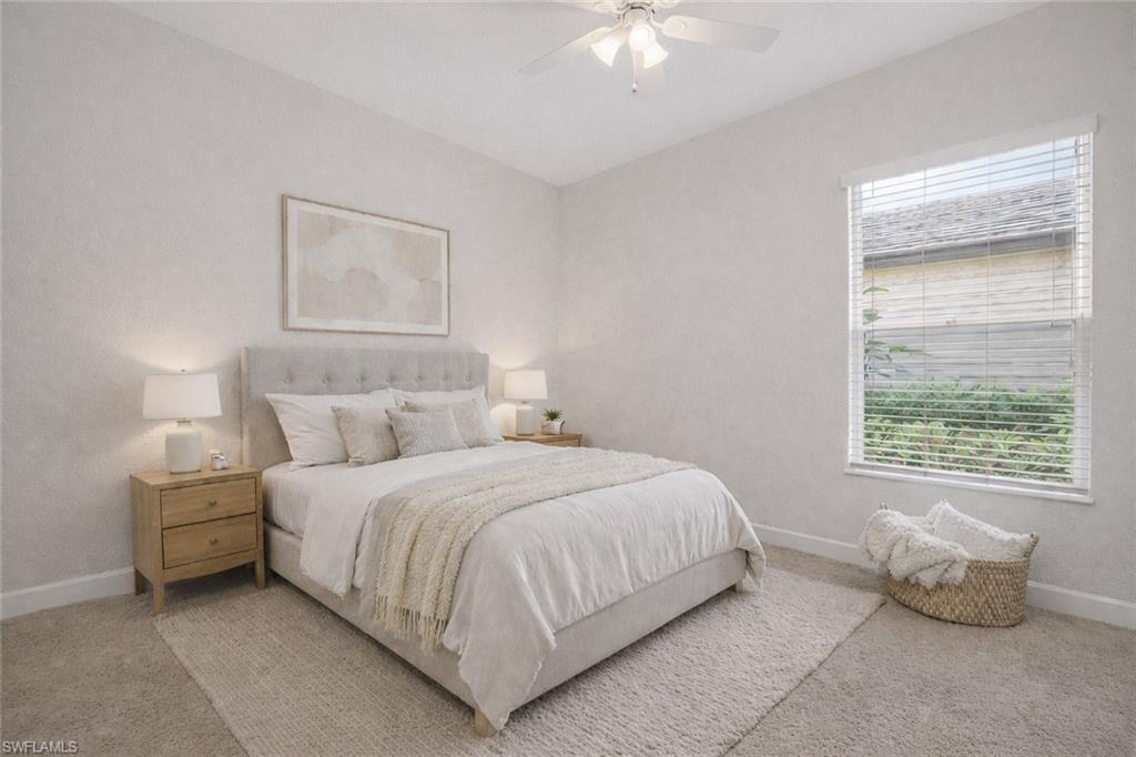 8968 Morgan Court Naples, FL 34113 - Photo 17 of 32 a bedroom with a bed and a chandelier