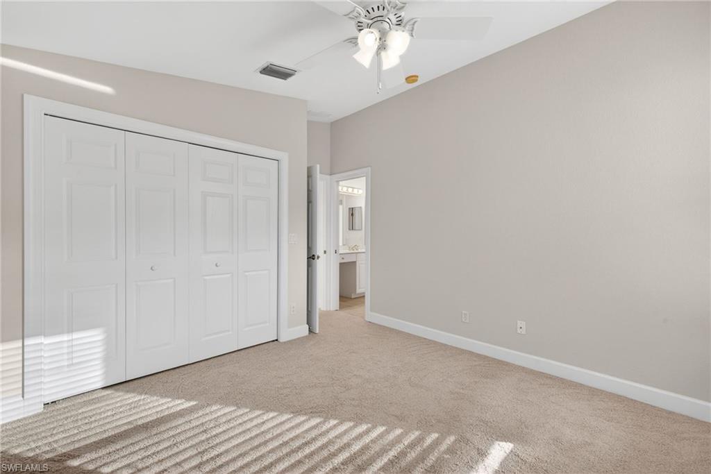 8968 Morgan Court Naples, FL 34113 - Photo 18 of 32 a view of an empty room with wooden floor