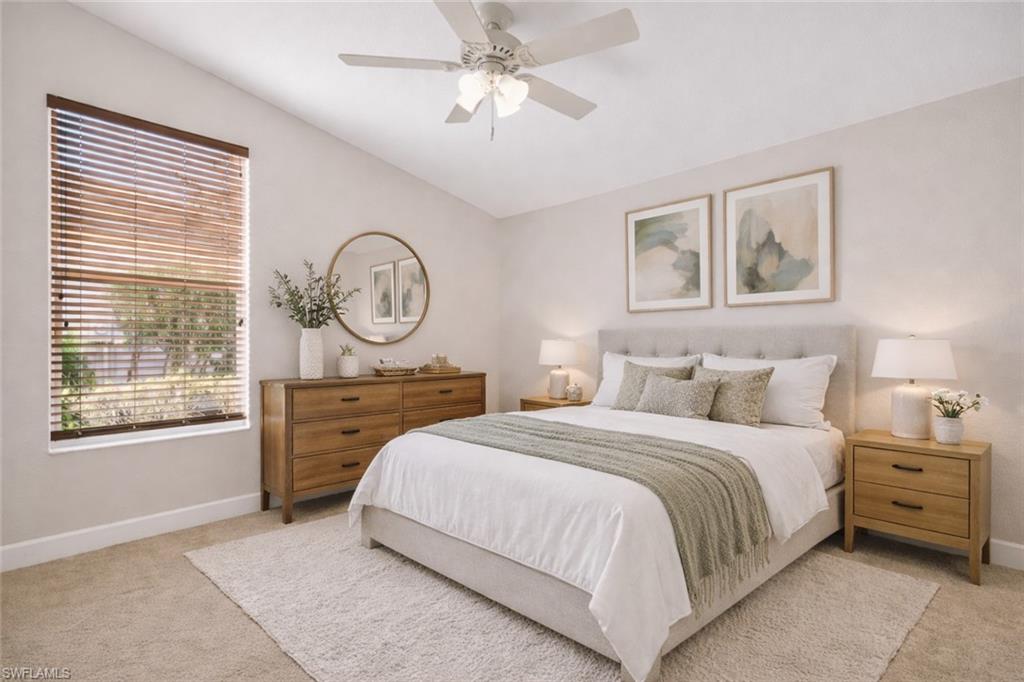 8968 Morgan Court Naples, FL 34113 - Photo 20 of 32 a bedroom with a bed a dresser and a large window