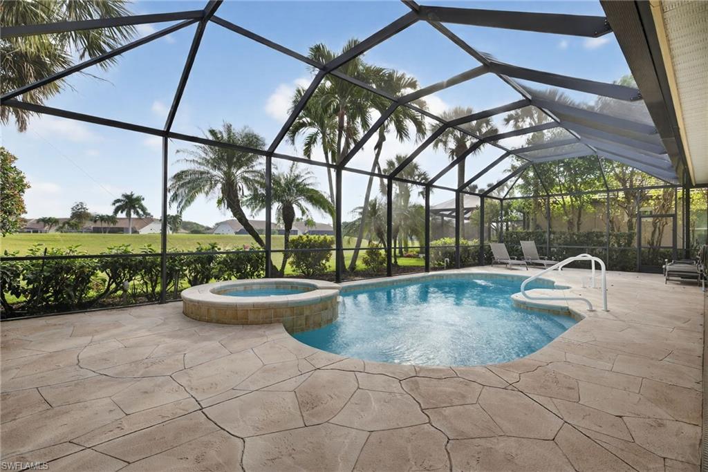 8968 Morgan Court Naples, FL 34113 - Photo 25 of 32 a view of a swimming pool with a patio