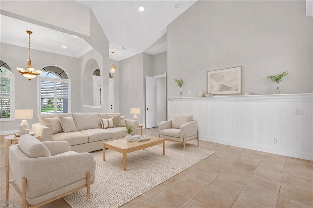 8968 Morgan Court Naples, FL 34113 - Photo 5 of 32 a living room with furniture and a chandelier