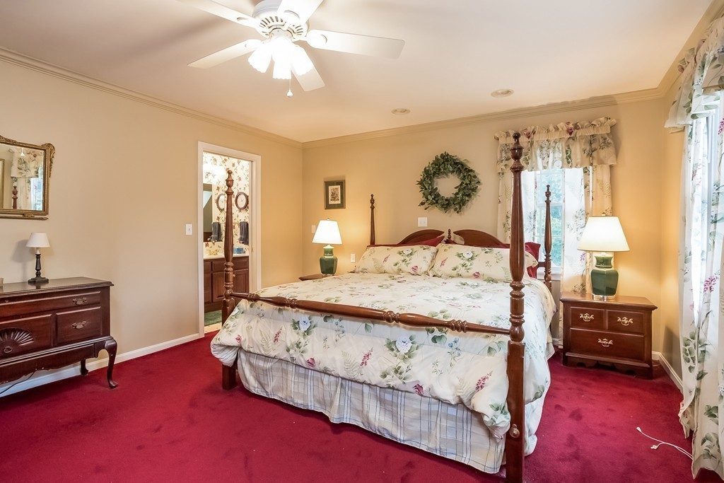 115 Bullivant Farm Road Marion, MA 02738 - Photo 6 of 30 a bedroom with a bed and a chandelier