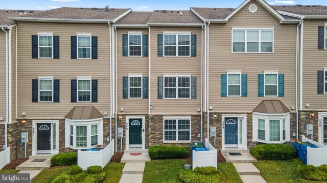 a front view of a residential apartment building with a yard