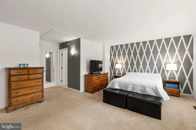 a bedroom with a bed and a television