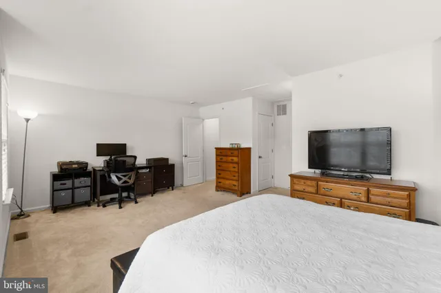 a bedroom with furniture and a flat screen tv
