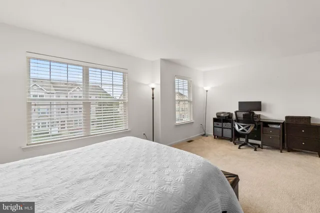 a bedroom with a bed and a desk