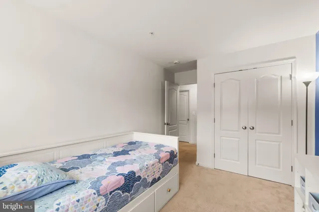 a bedroom with a bed and hallway