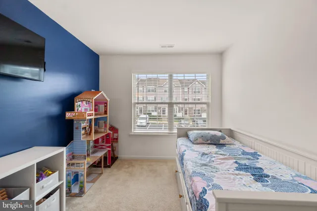 a bedroom with furniture and a window