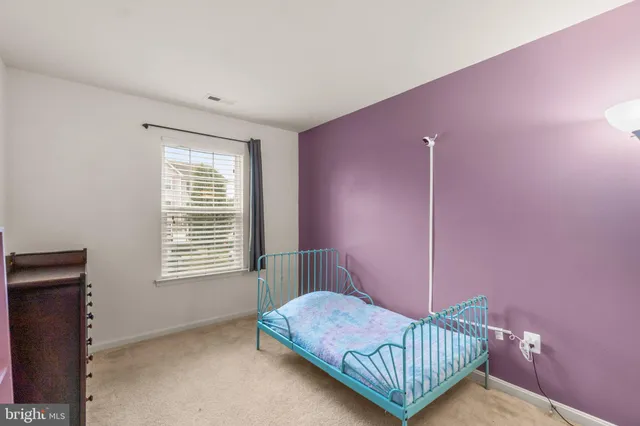 a bed room with a bed and a window