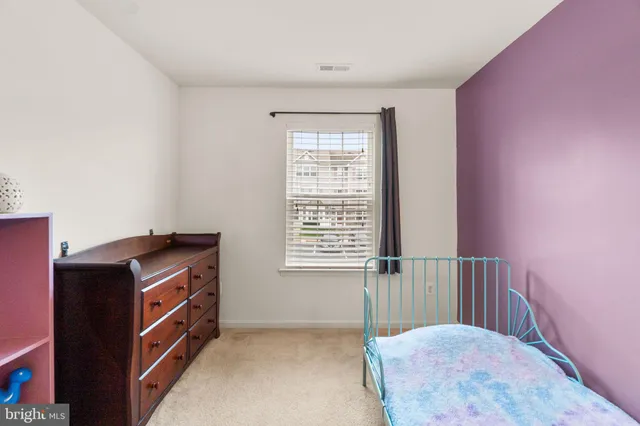 a hallway with a cabinet and a window