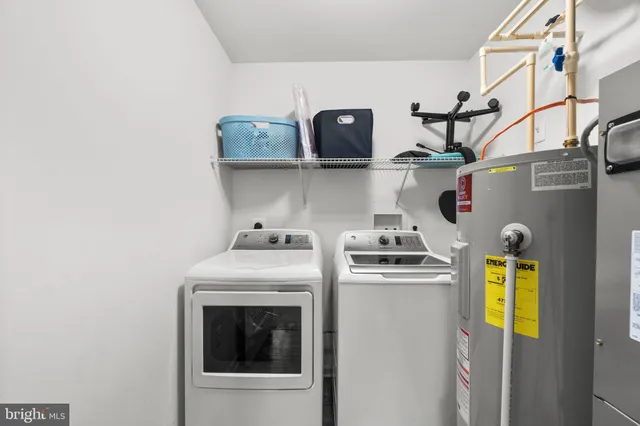 a close up of a storage and utility room with washer and dryer