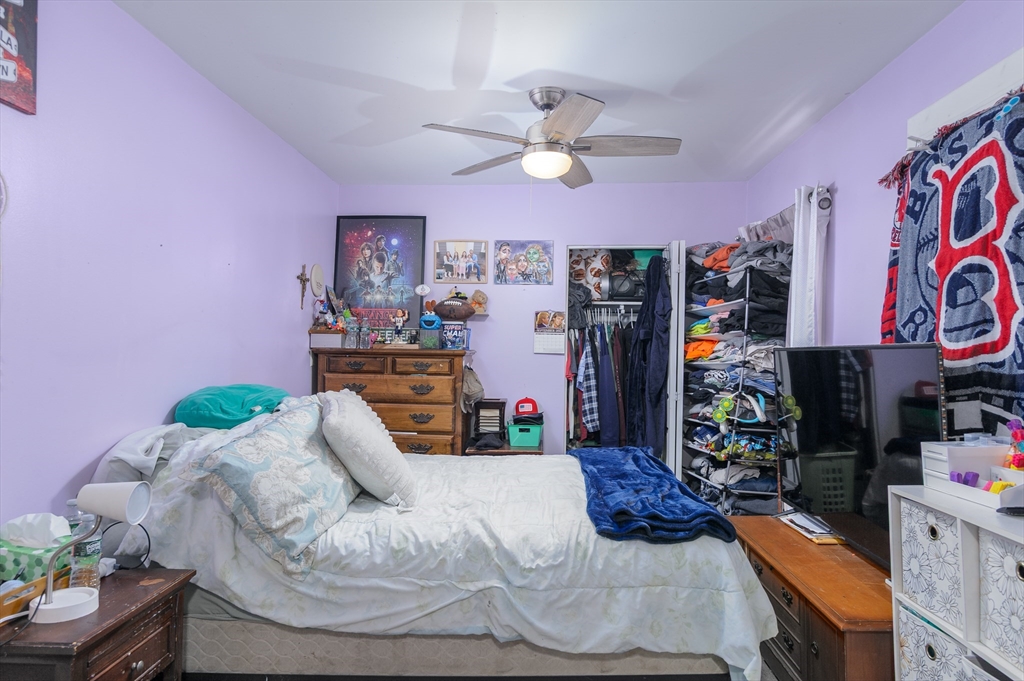 52 Grove Street Spencer, MA 01562 - Photo 17 of 24 a bedroom with bed and a chandelier