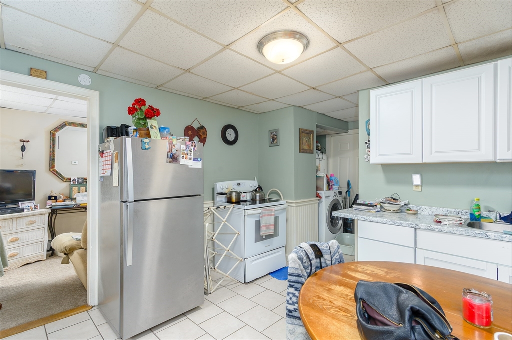 52 Grove Street Spencer, MA 01562 - Photo 10 of 24 a kitchen with refrigerator a sink and cabinets