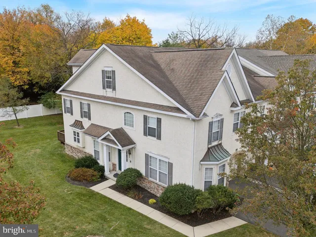 a view of a house with a big yard plants and large trees