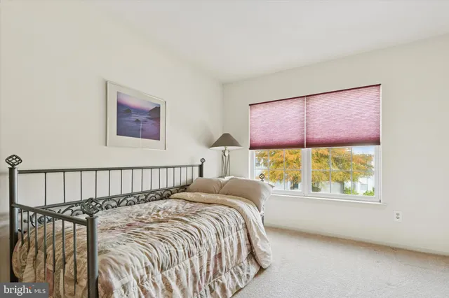 a bed sitting in a bedroom next to a window