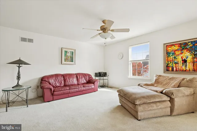 a living room with furniture a couch and a chandelier