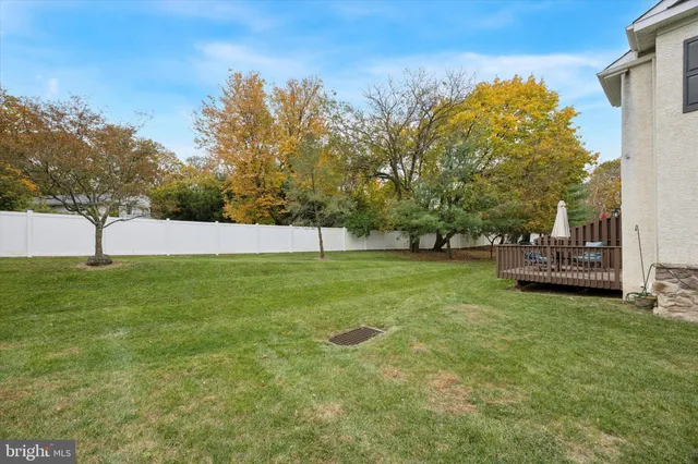 a view of yard with swimming pool and trees