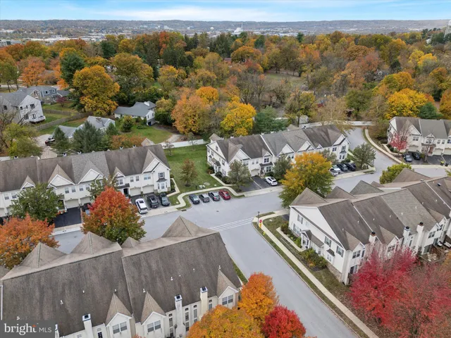 an aerial view of a house with yard swimming pool and lake view