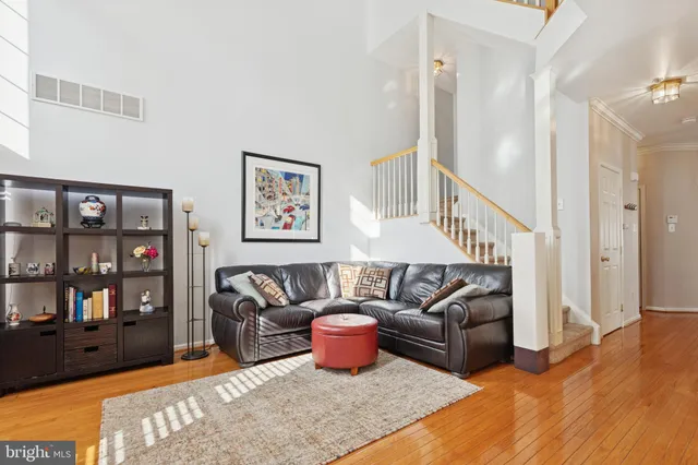 a view of a dining room with furniture a chandelier and wooden floor