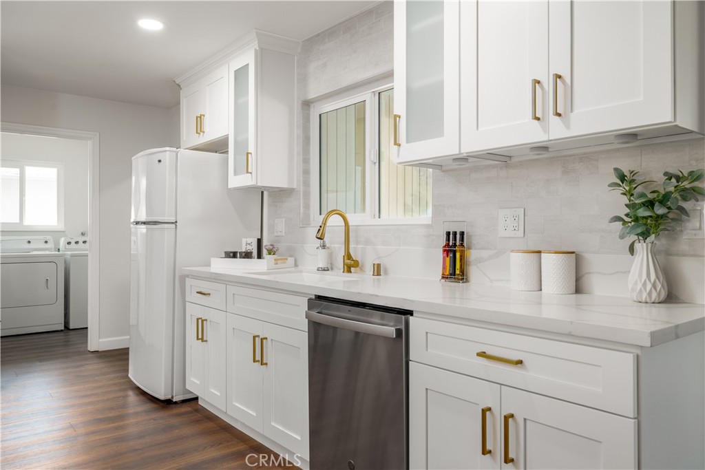 29110 Prestwick Road Menifee, CA 92586 - Photo 15 of 32 a kitchen with white cabinets and sink