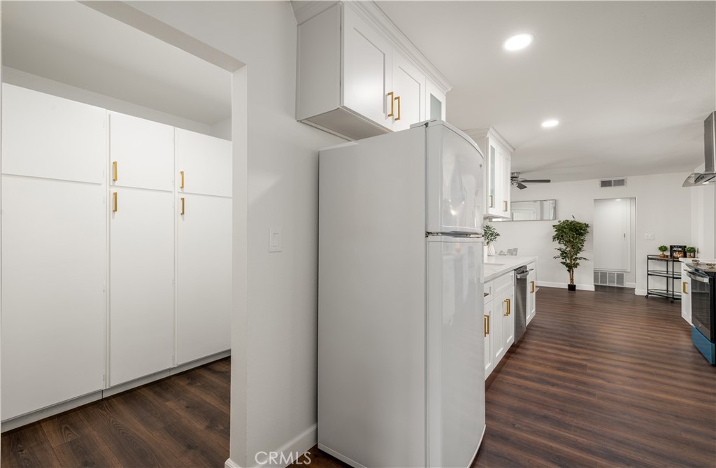 29110 Prestwick Road Menifee, CA 92586 - Photo 16 of 32 a kitchen with stainless steel appliances a refrigerator and wooden floor