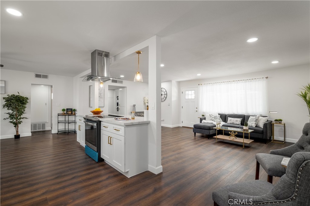 29110 Prestwick Road Menifee, CA 92586 - Photo 17 of 32 a kitchen with stainless steel appliances kitchen island hardwood floor sink and stove