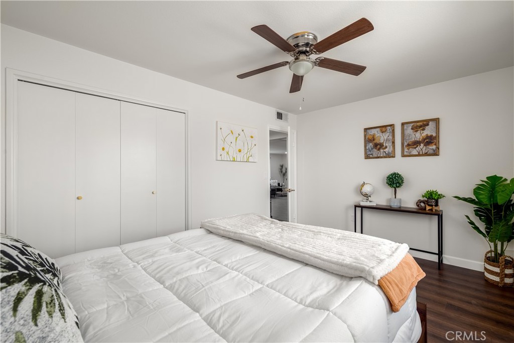 29110 Prestwick Road Menifee, CA 92586 - Photo 19 of 32 a bedroom with a large bed and a chandelier