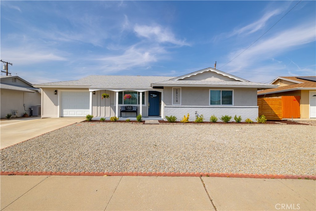 29110 Prestwick Road Menifee, CA 92586 - Photo 5 of 32 a front view of a house with a garden and yard