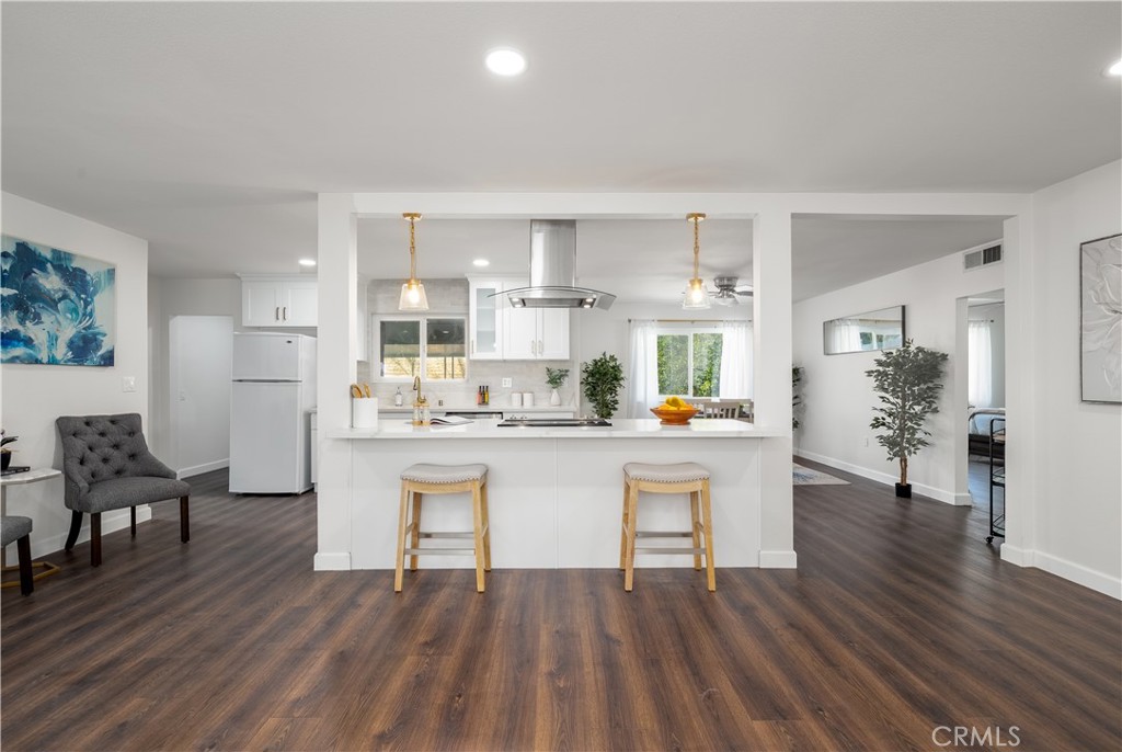 29110 Prestwick Road Menifee, CA 92586 - Photo 9 of 32 a kitchen with white cabinets and stainless steel appliances