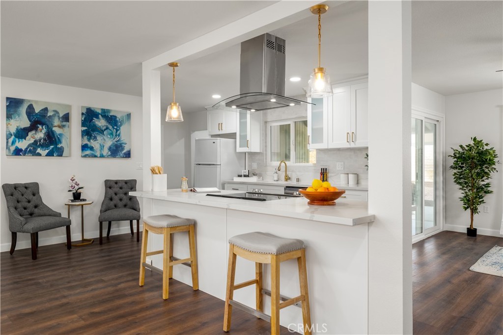29110 Prestwick Road Menifee, CA 92586 - Photo 10 of 32 a kitchen with a sink cabinets and wooden floor