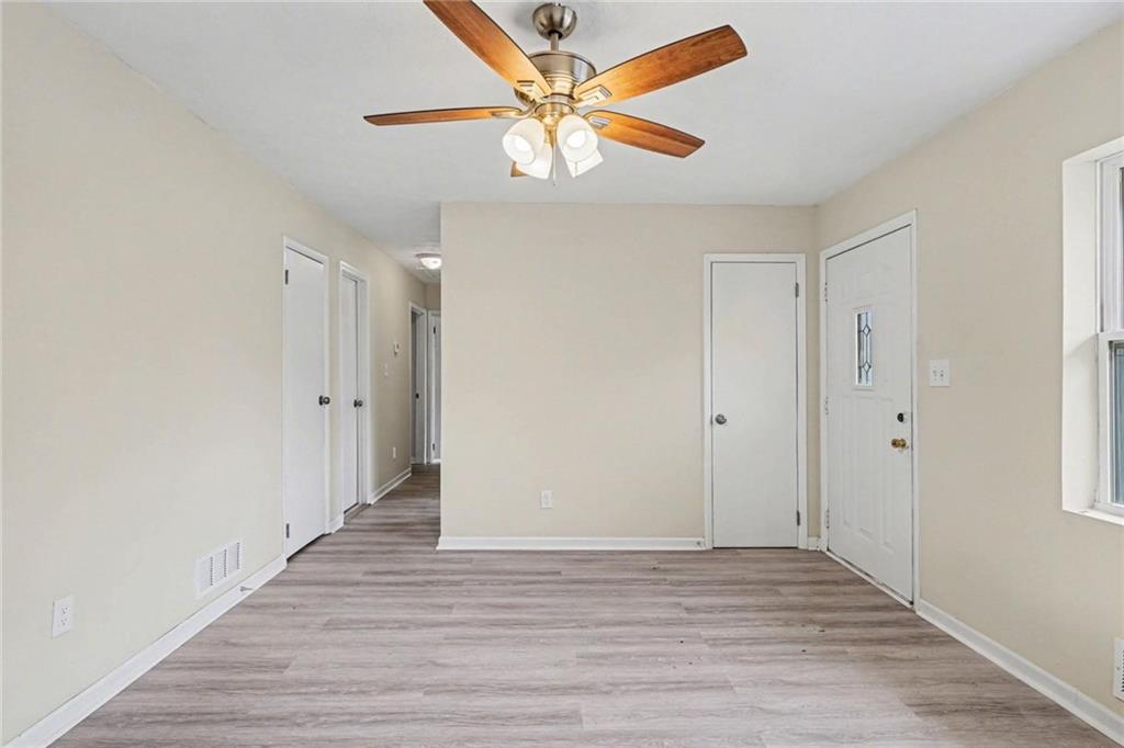 8355 Dunellen Lane Jonesboro, GA 30238 - Photo 11 of 27 a view of an empty room with window and wooden floor