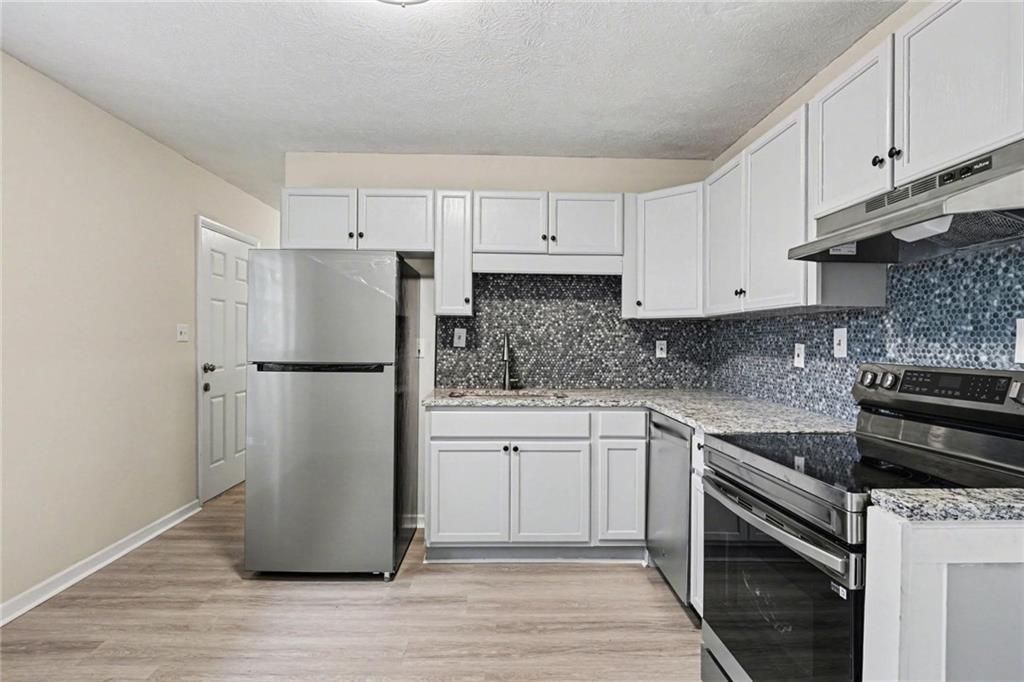 8355 Dunellen Lane Jonesboro, GA 30238 - Photo 15 of 27 a kitchen with a refrigerator sink and cabinets